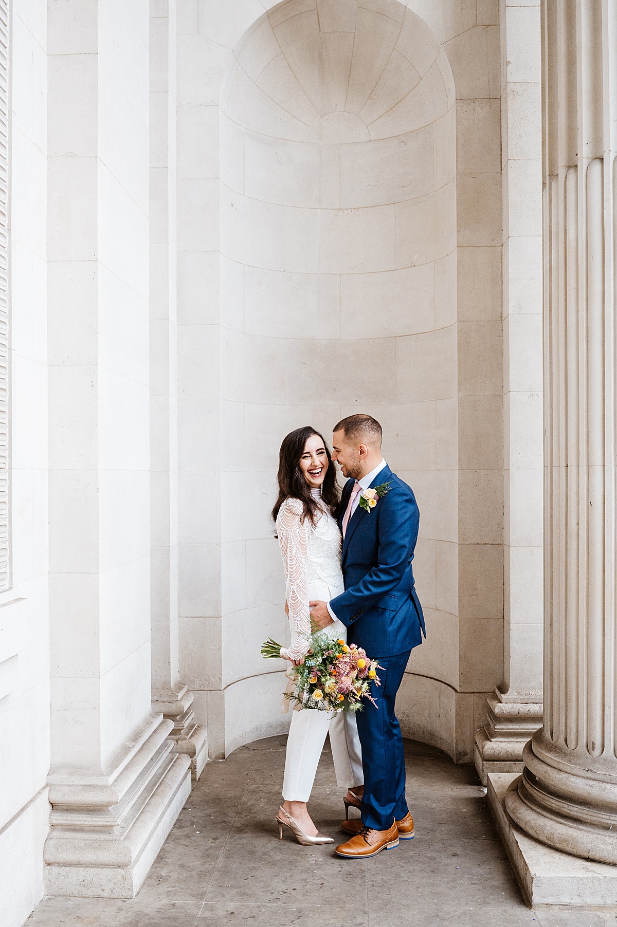 Old Marylebone Town hall wedding. Iconic image of bride and groom in the entrance to the town hall 